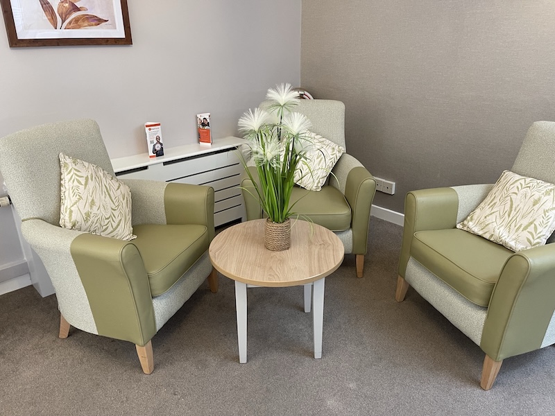 green armchairs in the corner of the lounge